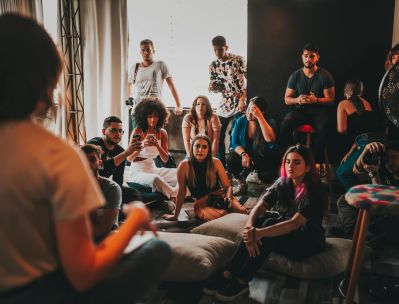 A diverse group gathered indoors in São Paulo for an engaging discussion session.